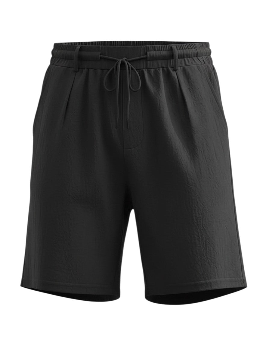 Short noir Maison Bryzen en tissu fluide avec taille élastique, cordon de serrage ajustable et poches fonctionnelles.